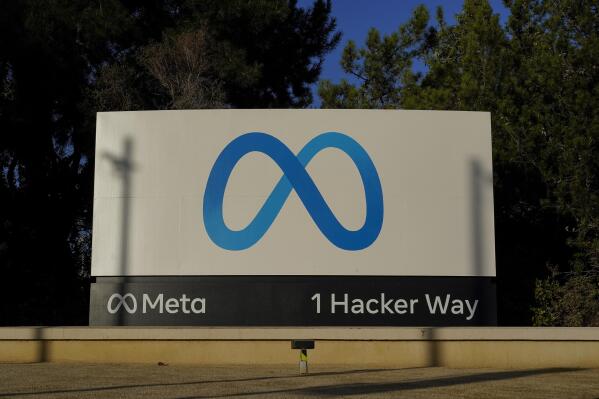 FILE - Meta's logo can be seen on a sign at the company's headquarters in Menlo Park, Calif., on Nov. 9, 2022. John Carmack cut his ties with Meta Platforms, a holding company created last year by Facebook founder Mark Zuckerberg, in a Friday, Dec. 16, 2022 letter that vented his frustration as he steeped down as an executive consultant in virtual reality.(AP Photo/Godofredo A. Vásquez, File)