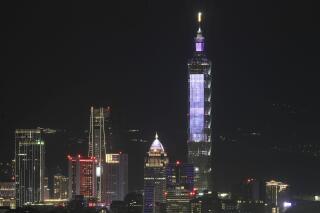 FILE - A view of the Taipei skyline at night with the iconic Taipei 101 skyscraper, the tallest building in Taiwan, in Taipei, Taiwan on Dec. 25, 2022. A visit by a Chinese official at the invitation of the Taiwanese capital's newly elected China-friendly mayor has drawn protests on the self-ruled island. (AP Photo/Chiang Ying-ying, File)