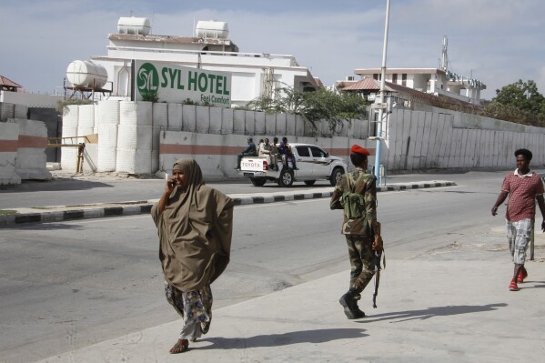 FILE - Somali security forces guard the entrance to the SYL hotel which was attacked by al-Shabab Islamic extremist rebels on Tuesday night, in Mogadishu, Somalia Wednesday, Dec. 11, 2019. The Somali extremist group al-Shabab says on Thursday, March 14, 2024, its fighters have attacked a hotel in the capital Mogadishu, where a loud explosion and gunfire have been heard. Al-Shabab said on its Telegram channel that its fighters managed to penetrate the SYL hotel, which is located not far from the presidential palace in a normally secure part of Mogadishu. (AP Photo/Farah Abdi Warsameh, File)