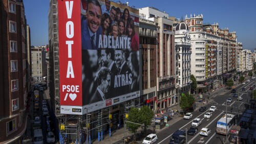 A gigantic electoral poster shows the president of the Spanish government and candidate of the Socialist Party, Pedro Sanchez, above, and the leader of the conservative Popular Party, Albert Nunez Feijoo, and the far-right group Vox, Santiago Abascal, in a building on Gran Via in Madrid, Spain, on July 10, 2023. (AP Photo/Manu Fernandez)