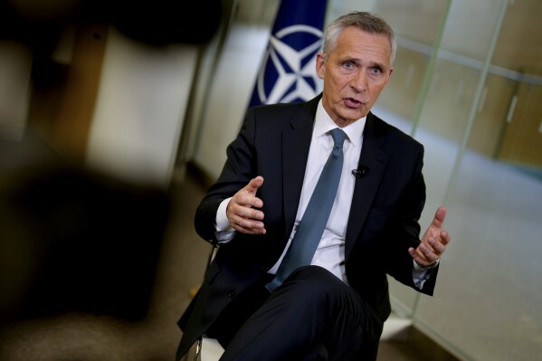 NATO Secretary General Jens Stoltenberg speaks during an interview at NATO headquarters in Brussels, Wednesday, June 21, 2023. Stoltenberg says the organization faces a series of challenges as it tries to tackle climate change while ensuring that its member nations still have effective fighting forces. Fighting global warming has become a priority for NATO just as its members struggle to supply Ukraine with enough weapons and ammunition to defend itself from Russia. (AP Photo/Virginia Mayo)