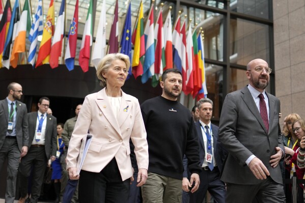 FILE - From left, European Commission President Ursula von der Leyen, Ukraine's President Volodymyr Zelenskyy and European Council President Charles Michel walk together during an EU summit in Brussels on Feb. 9, 2023. The European Union decided Thursday, Dec. 14, 2023 to open accession negotiations with Ukraine, a stunning reversal for a country at war that had struggled to find the necessary backing for its membership aspirations and long faced opposition from Hungarian Prime Minister Viktor Orban. (AP Photo/Virginia Mayo, File)