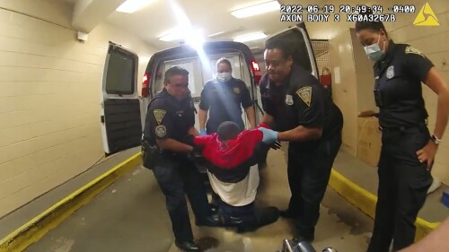 FILE - In this image taken from police body camera video provided by New Haven, Conn., Police, Richard "Randy" Cox, center, is pulled from the back of a police van and placed in a wheelchair after being detained by New Haven Police, June 19, 2022, in New Haven, Conn. Two more Connecticut police officers were fired Wednesday, June 28, 2023, for what officials called their misconduct and lack of compassion in how they treated Cox after he was paralyzed in the back of a police van last year. (New Haven Police via AP, File)