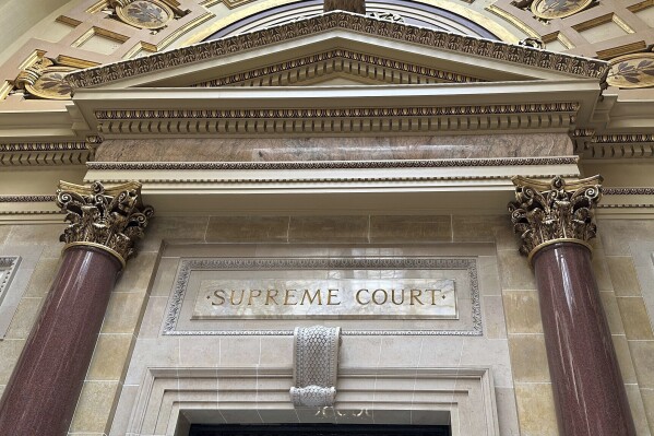 FILE - The entrance to the Wisconsin Supreme Court chambers is seen in the state Capitol in Madison, Wis. March 14, 2024. The Wisconsin Supreme Court is scheduled to hear arguments Wednesday, April 17, 2024, in Democratic Gov. Tony Evers’ lawsuit against the Republican-controlled Legislature, arguing that it is unconstitutionally blocking funding for a state conservation program. (AP Photo/Todd Richmond, File)