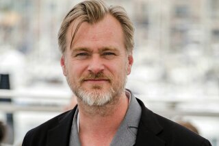 FILE - In this May 12, 2018, file photo, director Christopher Nolan poses during a photo call at the 71st international film festival in Cannes, southern France. Nolan, one of Warner Bros.’ most important filmmakers, has come out strongly against the company’s decision to send all of its films to HBO Max in 2021. (Photo by Arthur Mola/Invision/AP, File)