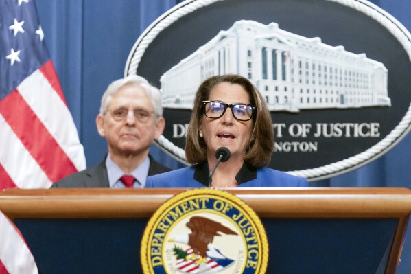 FILE - Deputy Attorney General Lisa Monaco speaks as Attorney General Merrick Garland listens during a news conference at Department of Justice headquarters in Washington, March 21, 2024. The Justice Department is ramping up its efforts to reduce violent crime in the U.S., launching a specialized gun intelligence center in Chicago and expanding task forces to curb carjackings. Deputy Attorney General Lisa Monaco tells The Associated Press there's “absolutely much more to do” to make communities safer, even as many places have experienced a downward trend in crime after a coronavirus pandemic-era spike. (AP Photo/Jose Luis Magana)