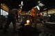 Craftsmen Suebsai Seksuk, left, a Thai native living in Japan, and Katsunori Suzuki pour molten iron into a mould while making a cast iron pot by hand at the Oigen foundry in Oshu, northeastern Japan, Thursday, May 16, 2024. (AP Photo/Hiro Komae)