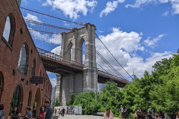 The Brooklyn Bridge is seen in New York on Monday, June 10, 2024. Social media users are sharing videos showing banners from the HBO series "House of the Dragon" hanging from the Brooklyn and Manhattan bridges, falsely claiming that the banners are real. (Melissa Goldin via AP)