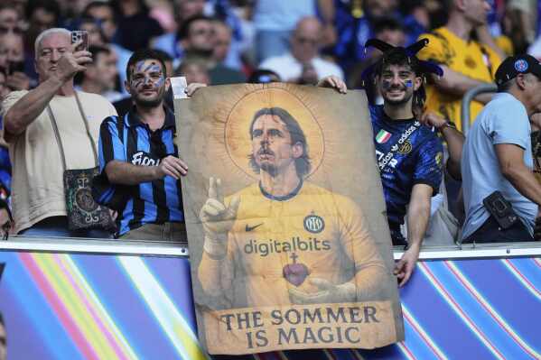 Inter Milan fans hold a depiction of Inter Milan's goalkeeper Yann Sommer before the Champions League final soccer match between Paris Saint-Germain and Inter Milan at the Allianz Arena in Munich, Germany, Saturday, May 31, 2025. (AP Photo/Matthias Schrader)