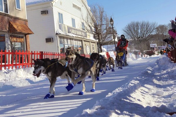 FILE - Patty Richards from Vermont takes off with her team of sled dogs at the start of the Can-Am 100 Saturday, March 5, 2022 in Fort Kent, Maine. The organizers of the longest sled dog race in the eastern United States said Monday, Feb. 26, 2024, they are canceling the event due to a lack of snow on the ground. The Can-Am Crown International Sled Dog Races have taken place in northern Maine for more than three decades, and they include a 250-mile event that is the marquee sled dog race in New England. But this year, snow has been well below average in Maine, and it's not safe to run the races, organizers said.(Emily Jerkins/The Bangor Daily News via AP, File)/The Bangor Daily News via AP, File)