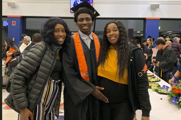 FILE - This 2019 photo provided by Porscha Banks shows Dexter Reed, center, along with his mother Nicole Banks and sister Porscha Banks. Reed, who was killed in a traffic stop where plainclothes Chicago police officers fired their guns nearly 100 times, was hit 13 times, according to an autopsy report released Thursday, April 25, 2024. (Porscha Banks via AP, File)