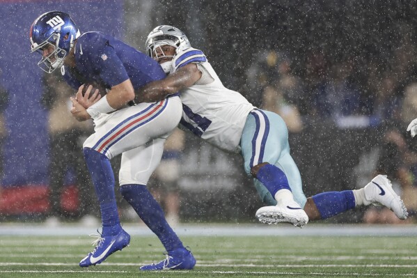 Dallas Cowboys' Micah Parsons, right, sacks New York Giants quarterback Daniel Jones during the second half of an NFL football game, Sunday, Sept. 10, 2023, in East Rutherford, N.J. (AP Photo/Adam Hunger)