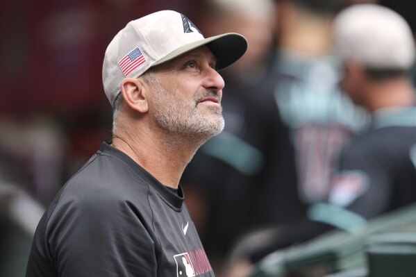Arizona Diamondbacks manager Torey Lovullo pauses in the dugout prior to a baseball game against the Colorado Rockies Saturday, May 17, 2025, in Phoenix. (AP Photo/Ross D. Franklin)
