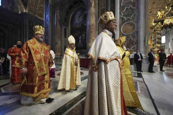 Cardinals arrive in procession for a mass on the seventh of nine days of mourning for late Pope Francis, in St. Peter's Basilica, at the Vatican, Friday, May 2, 2025. (AP Photo/Andrew Medichini)
