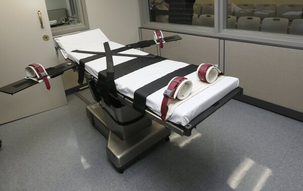 FILE - This Oct. 9, 2014, file photo shows the gurney in the the execution chamber at the Oklahoma State Penitentiary in McAlester, Okla. A group of doctors are asking corrections departments in states with the death penalty to release any stockpiles they might have of execution drugs to hospitals so they could be used to treat COVID‐19 patients. Many of the medications being used to help patients on ventilators are the same drugs used when putting inmates to death by lethal injection. (AP Photo/Sue Ogrocki, File)