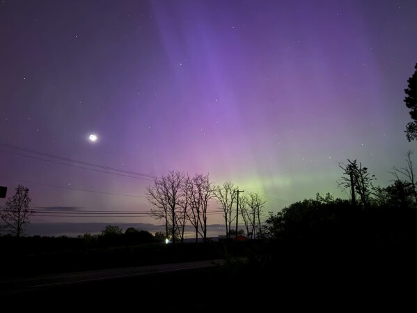 The Aurora Borealis, also known as the Northern Lights, is visible over Ann Arbor, Mich., early Saturday, May, 11, 2024. (AP Photo/Dee-Ann Durbin)