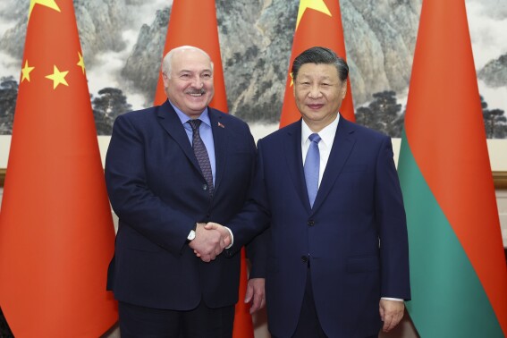 In this photo released by Xinhua News, Chinese President Xi Jinping, right, shakes hands with visiting Belarusian President Alexander Lukashenko prior the bilateral meeting in Beijing, Monday, Dec. 4, 2023. Chinese leader Xi Jinping spoke of a "strengthened political mutual trust and international coordination" with Belarus after he met with the European country's president in Beijing, according to official media. (Huang Jingwen/Xinhua via AP)