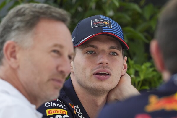 Red Bull driver Max Verstappen of the Netherlands reacts while talking to Red Bull team principal Christian Horner, left, outside their team garage ahead of the Australian Formula One Grand Prix at Albert Park, Melbourne, Australia, Thursday, March 21, 2024. (AP Photo/Asanka Brendon Ratnayake)