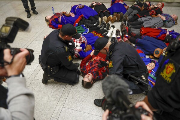 FILE - Demonstrators take part in a lie-in at the Norwegian Parliament in Oslo, Wednesday, Oct. 11 2023. Some 20 activists in Norway who last year blocked several entrances to government offices, saying a wind farm hinders the rights of the Sami Indigenous people to raise reindeer, have been charged, the lawyer said Friday, Jan. 19, 2024. (Frederik Ringnes/NTB Scanpix via AP, File)
