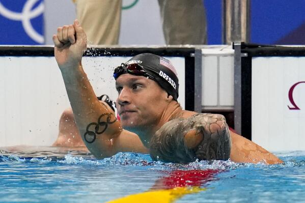 Caeleb Dressel, of United States, celebrates winning a men's 100-meter butterfly semifinal at the 2020 Summer Olympics, Friday, July 30, 2021, in Tokyo, Japan. (AP Photo/Gregory Bull)
