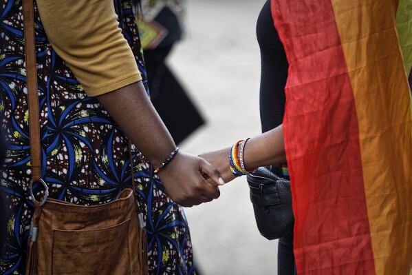 FILE - Activists from the LGBTQ community and their supporters commiserate after a ruling by the High Court upheld sections of the penal code that criminalize same-sex relations in Nairobi, Kenya, on May 24, 2019. Law enforcement authorities in Nigeria are using the country’s same-sex prohibition law to target the LGBTQ+ community while ignoring abuses against them, rights groups and lawyers say, in the wake of fresh mass arrests of gay people. Nigeria is one of more than30 countries in Africa where where homosexuality is criminalized. (AP Photo/Ben Curtis, File)
