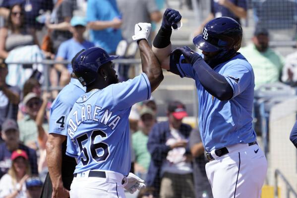 Tampa Bay Rays' Randy Arozarena (56) greets teammate Mike Zunino (10) after he hit a two-run home run in the second inning of a spring training baseball game during the Atlanta Braves at the Charlotte Sports Park, Saturday March 19, 2022, in Port Charlotte, Fla. (AP Photo/Steve Helber)