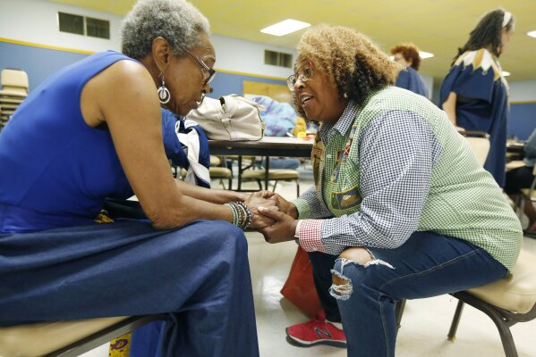 
              In this Aug. 24, 2018 photo, Cindy Ayers, CEO of Foot Print Farms, right, confers with her friend Imalika Adams Johnson, a veteran of the civil rights movement, at a Black Women Matter Issues Forum of several Mississippi grassroots political organizations with the Black Voters Matter Fund field team in Jackson, Miss. Black women are collaborating across states and across the country to maximize their efforts. Many have worked together on previous campaigns or on other grassroots projects in black communities, bringing a familiarity to the work they now share. (AP Photo/Rogelio V. Solis)
            