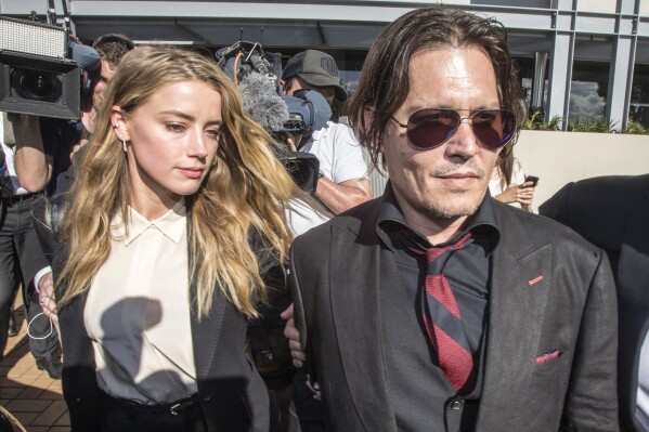 Johnny Depp and his then wife Amber Heard leave The Southport Court in Southport, Queensland, Australia, on April 18, 2016 after Heard pleaded guilty to providing a false document after failing to tell customs she was entering the country with the pair's Yorkshire terriers. Australian prosecutors dropped a potential criminal case against American actor Heard over allegations that she lied to a court about how her Yorkshire terriers Pistol and Boo came to be smuggled into Australia eight years ago, the government said Wednesday, Aug. 23, 2023. (Glenn Hunt/AAP Image via AP)