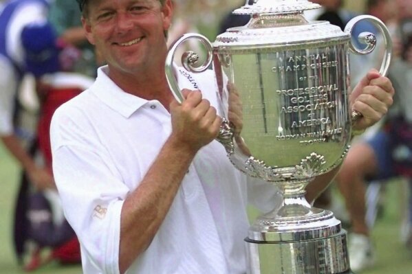 FILE - Mark Brooks holds the Wannamaker trophy on the 18th green of Valhalla Golf Club after beating Kenny Perry in a one-hole playoff to win the PGA Championship on Sunday afternoon, Aug. 11, 1996, in Louisville, Ky. Valhalla hosts its fourth major championship on May 16-19, 2024. (AP Photo/Ed Reinke, File)