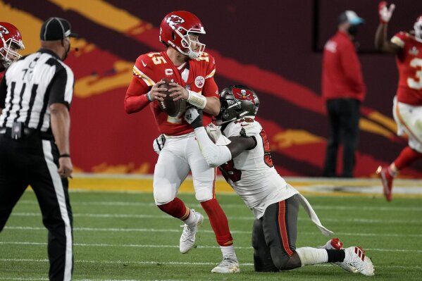 Kansas City Chiefs quarterback Patrick Mahomes (15) looks to throw a pass while in the grasp of Tampa Bay Buccaneers outside linebacker Shaquil Barrett, right, during the second half of the NFL Super Bowl 55 football game, Sunday, Feb. 7, 2021, in Tampa, Fla. (AP Photo/Chris O'Meara)