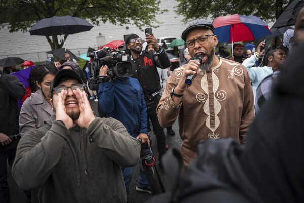 Protestors shout "Let him out" to demand the release of Newark Mayor Ras Baraka after his arrest while protesting outside an ICE detention prison, Friday, May 9, 2025, in Newark, N.J, (AP Photo/Angelina Katsanis)