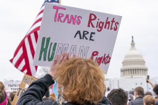 FILE - People attend a rally as part of a Transgender Day of Visibility, Friday, March 31, 2023, by the Capitol in Washington. The Associated Press on Friday, April 21, 2023 reported on social media users falsely claiming a map shows the states where it’s possible for a 3-year-old child to receive gender-affirming surgery. (AP Photo/Jacquelyn Martin, File)