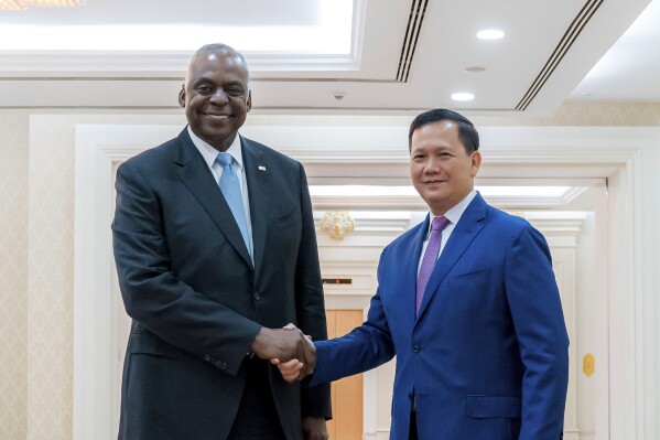In this photo released by Agence Kampuchea Press (AKP), U.S. Defense Secretary Lloyd Austin, left, shakes hands with Cambodian Prime Minister Hun Manet in Phnom Penh, Cambodia, Tuesday, June 4, 2024. Austin traveled to Cambodia on Tuesday to push for stronger military ties with China’s closest ally in Southeast Asia. (AKP via AP)