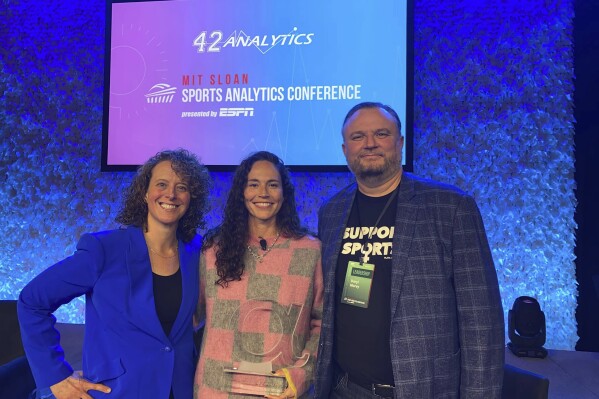 This March 2023 photo provided by the Sloan Sports Analytics Conference shows Sue Bird, center, posed with Jessica Gelman, left and Daryl Morley, right, after presenting Bird with the Lifetime Achievement Alpha Award at the 2023 Sloan Sports Analytics Conference in Boston. Jessica Gelman has become an influential leader and innovator in the sports industry. She co-founded the MIT Sloan Sports Analytics Conference. She teamed with Philadelphia 76ers President Daryl Morey to not only found Sloan, but guide it into the preeminent forum for number-crunchers. (Jeff Pinette/Sloan Sports Analytics Conference via 麻豆传媒app)