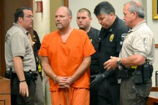 FILE - In this Friday, Nov. 2, 2018, file photo, Gregory Bush is led into a courtroom for an arraignment on murder charges in Louisville, Ky. Bush, convicted of fatally shooting two Black shoppers at a Kentucky grocery store, was sentenced Tuesday, Dec. 15, 2020, to life in prison without parole. (AP Photo/Dylan Lovan, File)