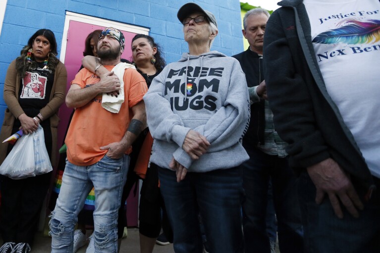 People listen at the start of a candlelight service for Nex Benedict, a nonbinary teenager who died one day after a fight in a high school bathroom, at Point A Gallery, Saturday, Feb. 24, 2024, in Oklahoma City. (Nate Billings/The Oklahoman via AP)