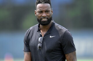 FILE - Former Detroit Lions wide receiver Calvin Johnson walks off the field after an NFL football practice in Allen Park, Mich., June 8, 2023. Pro Football Hall of Famer Johnson was chosen for induction into the Pride of the Lions, an honor that will put his name on permanent display at Ford Field. Lions chief operating officer Mike Disner surprised Johnson with the team’s plans Monday, July 15, 2024. (AP Photo/Paul Sancya, File)