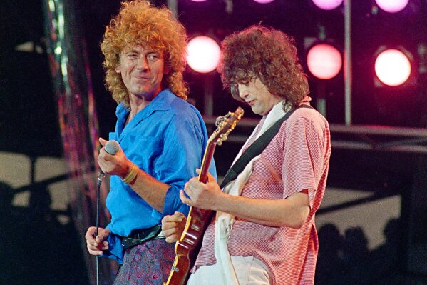 FILE - In this July 13, 1985 file photo, Led Zeppelin bandmates, singer Robert Plant, left, and guitarist Jimmy Page, reunite to perform for the Live Aid famine relief concert at JFK Stadium in Philadelphia. From left are John Bonham, Robert Plant, Denny and Jimmy Page. A federal appeals court on Monday, March 9, 2020, restored a jury verdict that found Led Zeppelin did not steal “Stairway to Heaven." (AP Photo/Amy Sancetta, File)