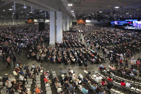 FILE - In this Wednesday, June 16, 2021, file photo, people attend the morning session of the Southern Baptist Convention annual meeting in Nashville, Tenn. Southern Baptists gathering at their next annual meeting June 11-12, 2024, in Indianapolis will vote on whether to enact a constitutional ban on churches with women pastors. (AP Photo/Mark Humphrey, File)