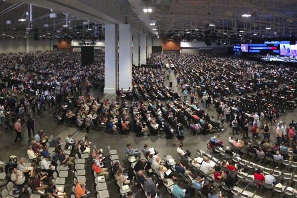 FILE - In this Wednesday, June 16, 2021, file photo, people attend the morning session of the Southern Baptist Convention's annual meeting in Nashville, Tenn.  Southern Baptists will meet at their next annual meeting in Indianapolis on June 11-12, 2024 to vote on whether to impose a constitutional ban on churches with female pastors.  (AP Photo/Mark Humphrey, File)