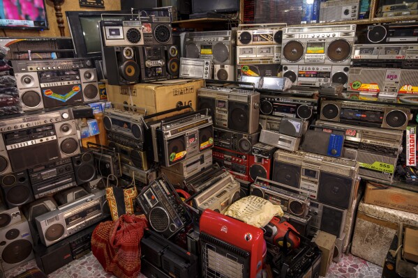 A stack of refurbished tape recorders for sale are seen in a shop in Srinagar, Indian controlled Kashmir, Friday, Feb. 14, 2025. (AP Photo/Dar Yasin)