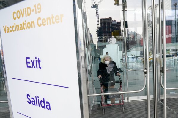 FILE - In this Jan. 13, 2021, file photo, Muriel Mandell, 99, leaves a New York State COVID-19 vaccination site at the Jacob K. Javits Convention Center after receiving her first dose in New York. An increasing number of COVID-19 vaccination sites around the U.S. are canceling appointments because of vaccine shortages in a rollout so rife with confusion and unexplained bottlenecks. (AP Photo/Mary Altaffer, File)