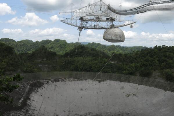 FILE - This July 13, 2016 photo shows the world's largest single-dish radio telescope at the Arecibo Observatory in Arecibo, Puerto Rico. The National Science Foundation announced Oct. 13, 2022 that it will not rebuild the renowned radio telescope, which was one of the world’s largest until it collapsed in August 2020. (AP Photo/Danica Coto, File)