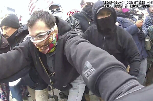 This image from police body-worn camera video, and contained in the Justice Department's sentencing memorandum, shows Marc Bru, at the U.S. Capitol on Jan. 6, 2021, in Washington. Bru, who stormed the U.S. Capitol with fellow Proud Boys extremist group members, has been sentenced to six years in prison. (Department of Justice via AP)