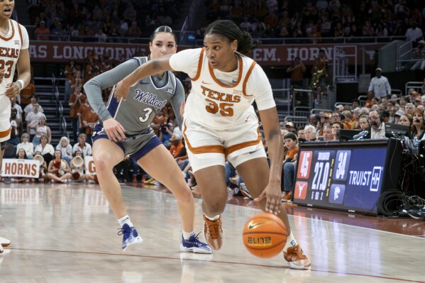 Texas guard Madison Booker (35) drives the ball against Kansas State guard Jaelyn Glenn (3) during the second half of an NCAA college basketball game, Sunday, Feb. 4, 2024, in Austin, Texas. (AP Photo/Michael Thomas)