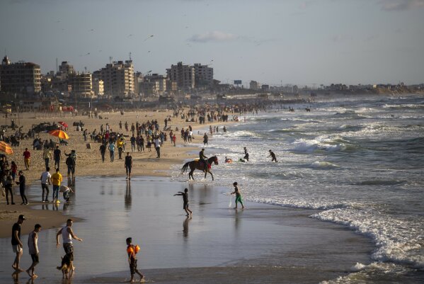 Palestinians enjoy a sunny day on the beach of Gaza City, Friday, May 29, 2020. (AP Photo/Khalil Hamra)