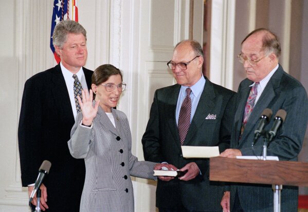 FILE - In this Aug. 10, 1993, file photo, Supreme Court Justice Ruth Bader Ginsburg takes the court oath from Chief Justice William Rehnquist, right, during a ceremony in the East Room of the White House in Washington. Ginsburg's husband Martin holds the Bible and President Bill Clinton watches at left. The Supreme Court says Ginsburg has died of metastatic pancreatic cancer at age 87. (AP Photo/Marcy Nighswander, File)