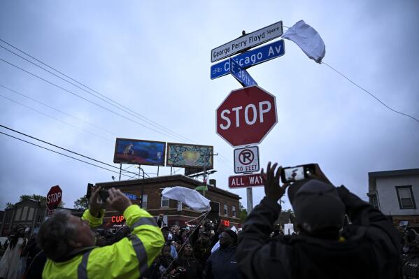 A new George Perry Floyd Square sign is unveiled in front of hundreds of community members Wednesday, May 25, 2022, in Minneapolis. The intersection where Floyd died at the hands of Minneapolis police officers was renamed in his honor Wednesday, among a series of events to remember a man whose killing forced America to confront racial injustice. (Aaron Lavinsky/Star Tribune via AP)