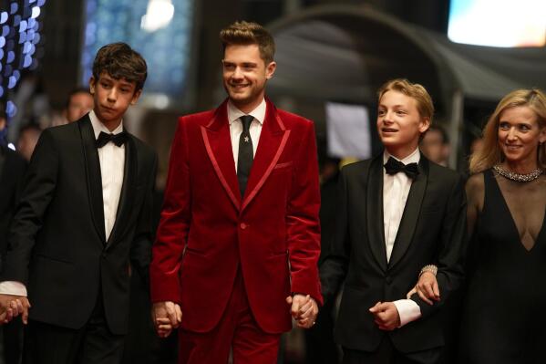 Gustav De Waele, from left, director Lukas Dhont, Eden Dambrine, and Emilie Dequenne pose for photographers upon arrival at the premiere of the film 'Close' at the 75th international film festival, Cannes, southern France, Thursday, May 26, 2022. (AP Photo/Petros Giannakouris)