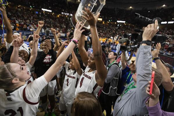 South Carolina's Aliyah Boston holds up the championship trophy after defeating Tennessee 74-58 to win the championship game of the Southeastern Conference women's tournament in Greenville, S.C., Sunday, March 5, 2023. (AP Photo/Mic Smith)
